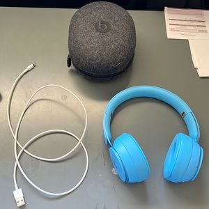Light blue Pharrell Williams beats by Dre headphones